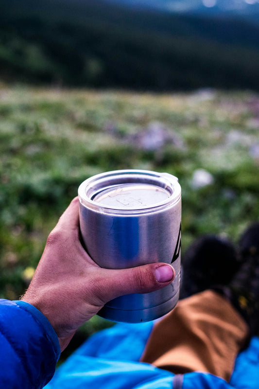 person holding blue and silver can