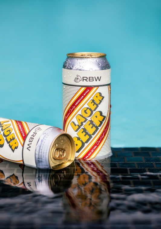 a can of beer next to a can of beer
