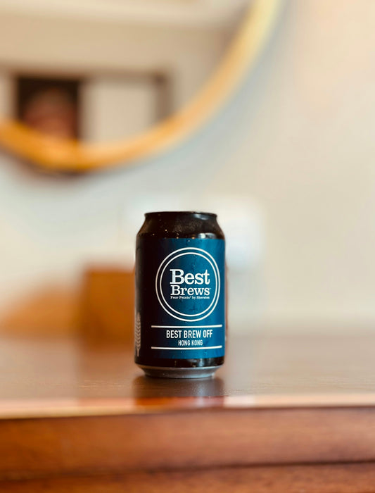 a can of beer sitting on top of a wooden table